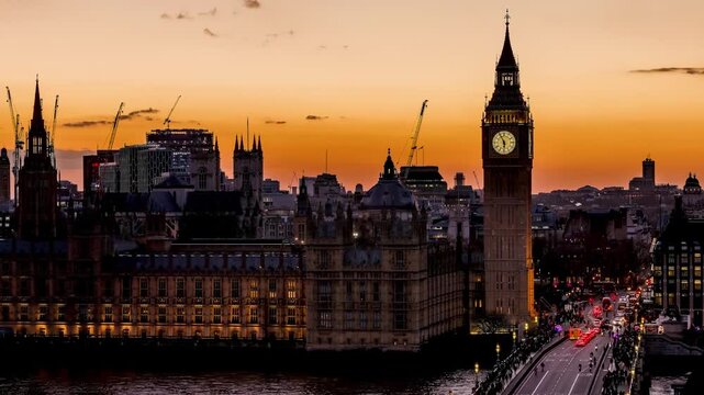 Close-up sunset to night time lapse view of the Big Ben clocktower in London with street and people traffic, England