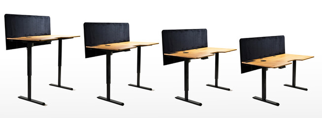 Adjustable Standing Desks with Wooden Tops Displayed in Multiple Heights..