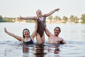 Joyful Family Bonding in a Scenic Outdoor Water Setting