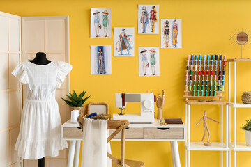 Interior of atelier with tailor's workplace, mannequin and sketches