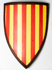 Historical Shield with Red and Yellow Vertical Design on White Background..