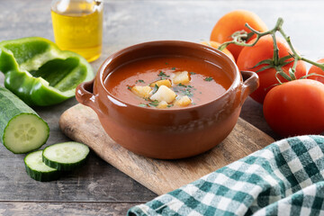 Traditional Spanish Gazpacho soup in bowl on wooden table