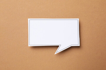 Blank speech bubble on brown background, top view. Space for text