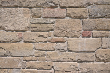 Background with a wall of well-carved brown stones