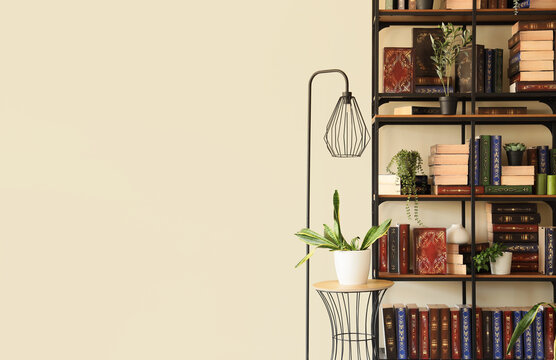Interior of home library with books, houseplants and lamp