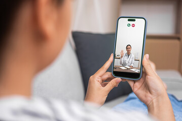 Online healthcare session with a doctor on smartphone, patient consultation at home. 