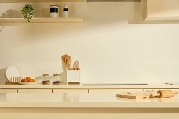 The kitchen with a luxurious marble dining table. The beige cabinets hold kitchen utensils. A...