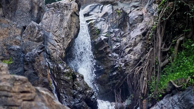 Top-down close-up of fresh mountain water cascading off a rocky cliff in Karnataka's Western Ghats