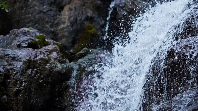 Top-down close-up of fresh mountain water cascading off a rocky cliff in Karnataka's Western Ghats
