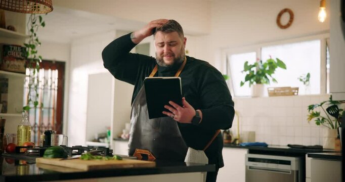 Man, home and frustrated in kitchen with tablet, doubt or confused as entrepreneur. Male person, issue and tech for tutorial question, research or recipe for private chef cooking or meal preparation