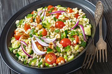 Barley salad with vegetables and walnuts in a bowl