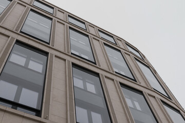 Windows of a high-rise building, view from bottom to top. Business concept of the future architecture.