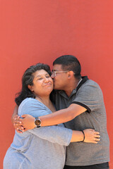 A 50-year-old divorced single mother and her 30-year-old dark-skinned Latino son show their love and celebrate Mother's Day together