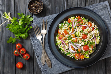 Barley salad with vegetables and walnuts in a bowl