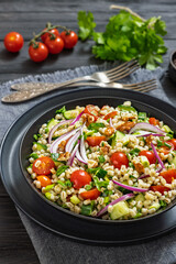 Barley salad with vegetables and walnuts in a bowl
