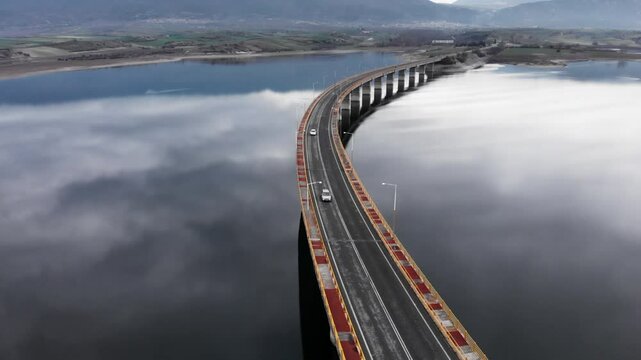 Cars on Servia High Bridge Captured by Drone Over Cloudy Lake