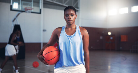 Portrait, player or serious black woman with basketball for sports, fitness, and confidence at gym. Girl, court or athlete in practice with hobby or pride for contest, workout challenge and exercise