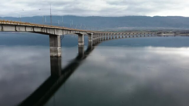 Moody Aerial Tracking Shot of High Bridge at Lake Polyfytos Greece