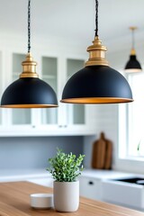Obraz premium Modern black and gold hanging lamps illuminating kitchen island