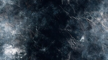 Dark, textured surface with varied shades of grey and blue.
