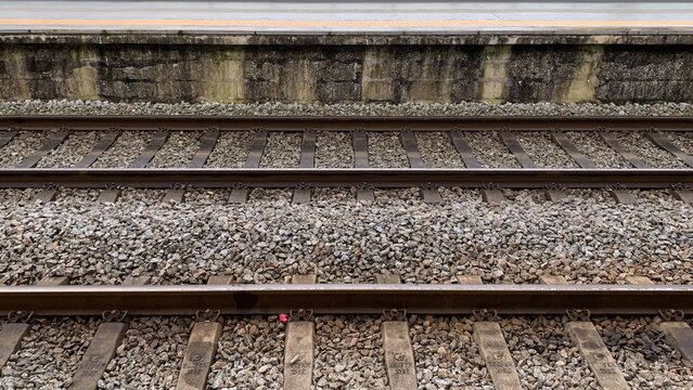 Empty railway tracks at a deserted station, symbolizing travel, solitude, and potential journeys on Railway Day 