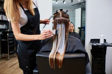 Hairdresser Painting Blonde Highlights in a Natural Hair