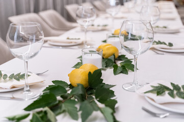 beautiful table decoration in restaurant. festive table setting in restaurant. white tablecloth on...