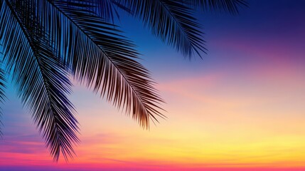 Obraz premium Serene sunset over tropical landscape with palm leaves framing a colorful sky