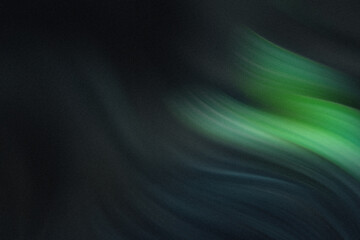 A small green sprout emerging from dark soil with three leaves in a close up view of new growth