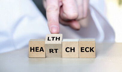 Naklejka premium Cubes form the expression 'heart check' and 'health check'.