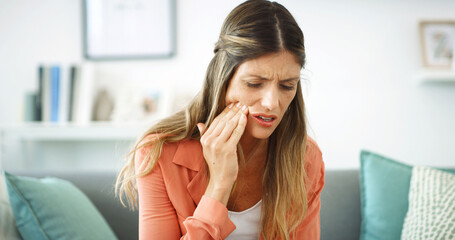 Woman, touch and cheek with toothache at house with cavity, dental problem and gum infection....