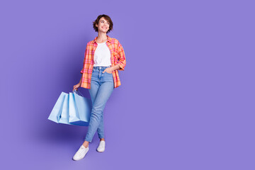Full body portrait of pretty young lady bags look empty space wear shirt isolated on purple color background
