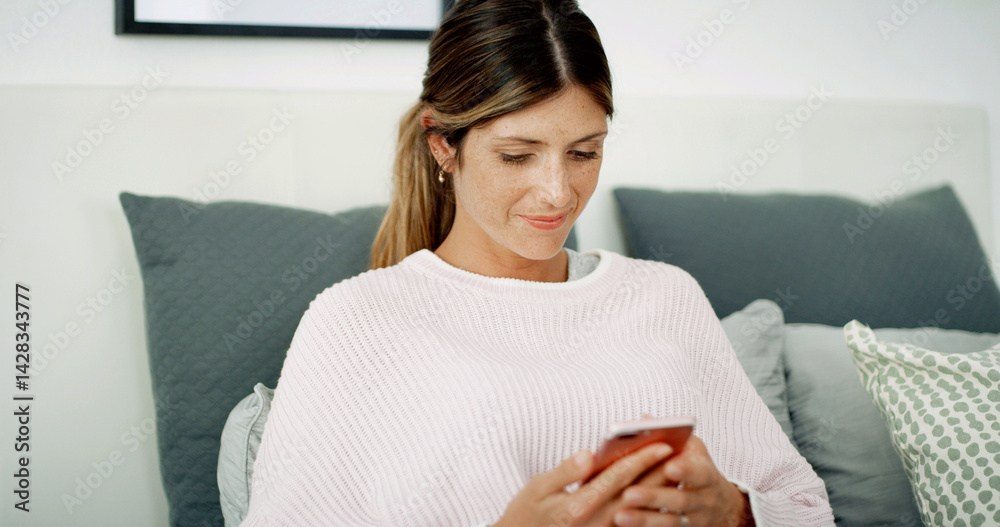 Poster woman, phone and smile with texting on sofa, chat and check notification in living room at in home. 