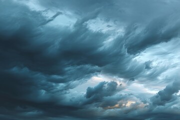 Obraz premium Dramatic storm clouds filling the sky, with an ominous yet beautiful gradient of dark blues and grays, creating a sense of impending weather and atmospheric tension.