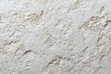 Close-up of a light beige travertine stone surface with natural pores and crevices, showcasing its rough texture and aged appearance in detailed macro photography.
