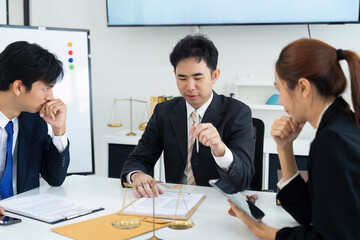 Legal Consultation and Client Planning. A lawyer presenting case documents to clients during an important meeting.