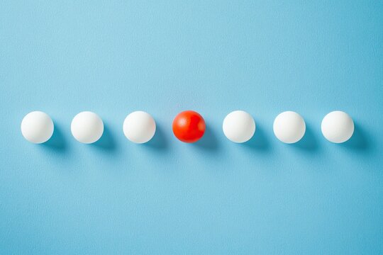 Red sphere among white spheres