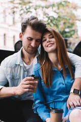 Couple peacefully cuddling and enjoying coffee outdoors