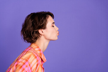 Profile portrait of nice young lady kiss empty space wear shirt isolated on purple color background