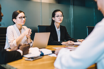Corporate employees sitting at meeting table having conference brainstorming for discussing business ideas and create startup strategy for progressive project, concept of briefing for search solutions