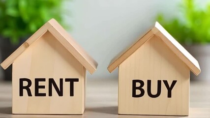 Buy or rent inscribed on wooden block houses, home and mortgage or renting concept