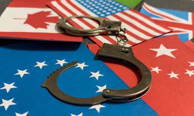 flags of different countries with handcuffs. Currency corruption in the country. Financial crimes