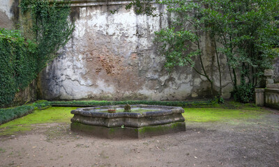 Old fountain in a park in Coimbra, Portugal.