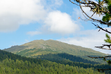 Mountain landscape. A hilltop illuminated by the evening sun. Ergaki Nature Park