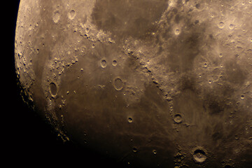Close-up photo of lunar terrain featuring deep craters and ridges