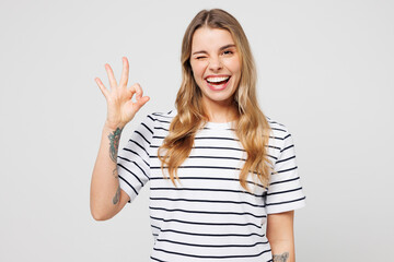 Young smiling happy cheerful fun satisfied positive woman wear striped t-shirt casual clothes...