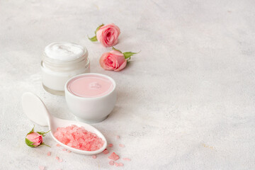 Closeup of pink roses and skin care cream with flowers essential oil