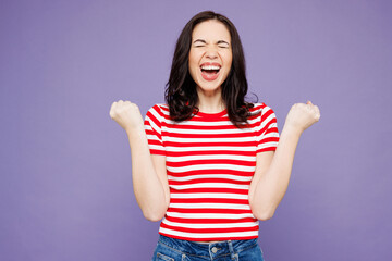 Young Caucasian woman wear red striped t-shirt casual clothes doing winner gesture celebrate clench...