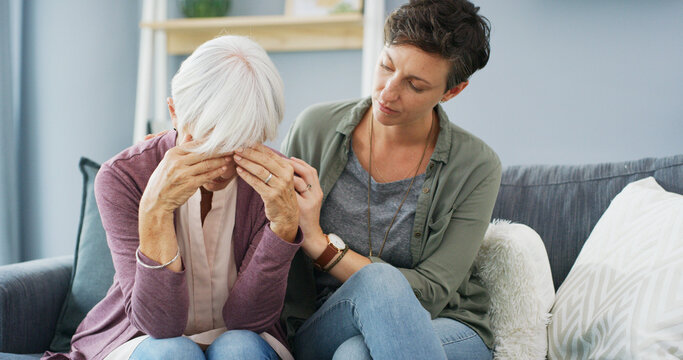 Support, sofa and woman with senior mother for grief, loss or emotions with care and empathy. Comfort, hug and female person helping elderly mom with sadness, memory or alzheimers in retirement home.