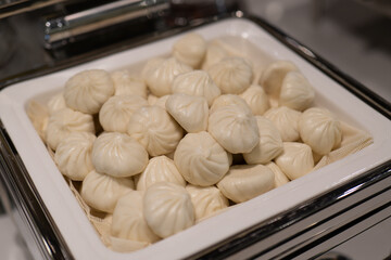 Freshly Steamed White Buns with Clear Pleats on Square White Tray